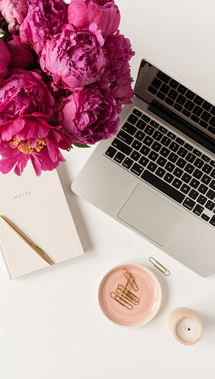 http://Laptop%20with%20design%20work%20next%20to%20flowers%20and%20coffee